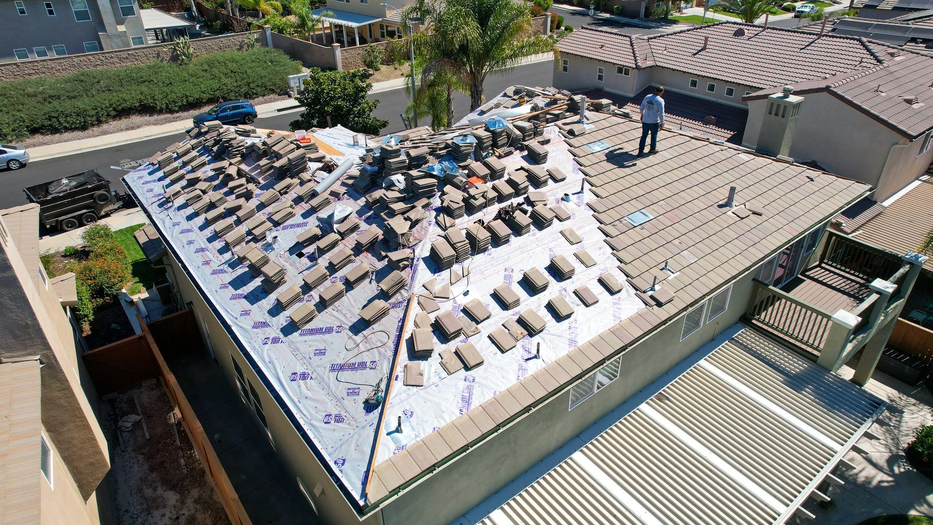 An aerial view of a roof that is being repaired