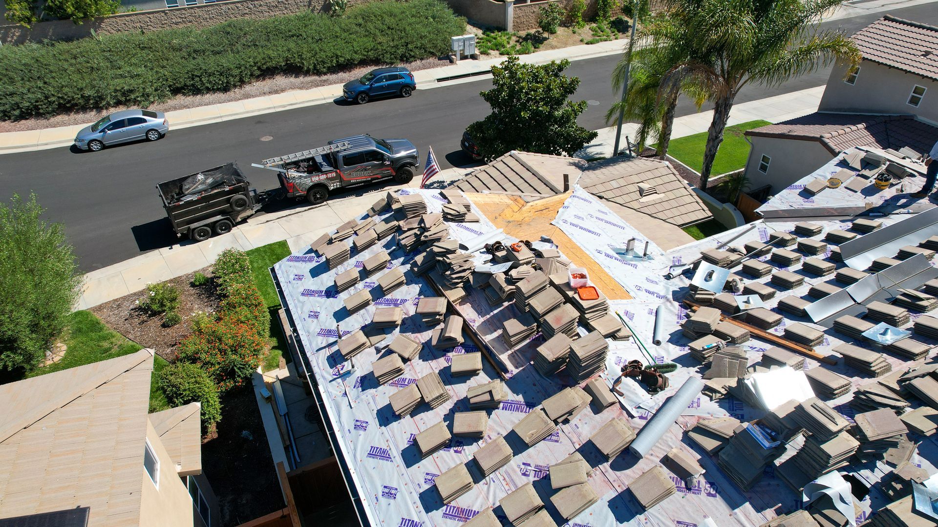 An aerial view of a roof that is being repaired