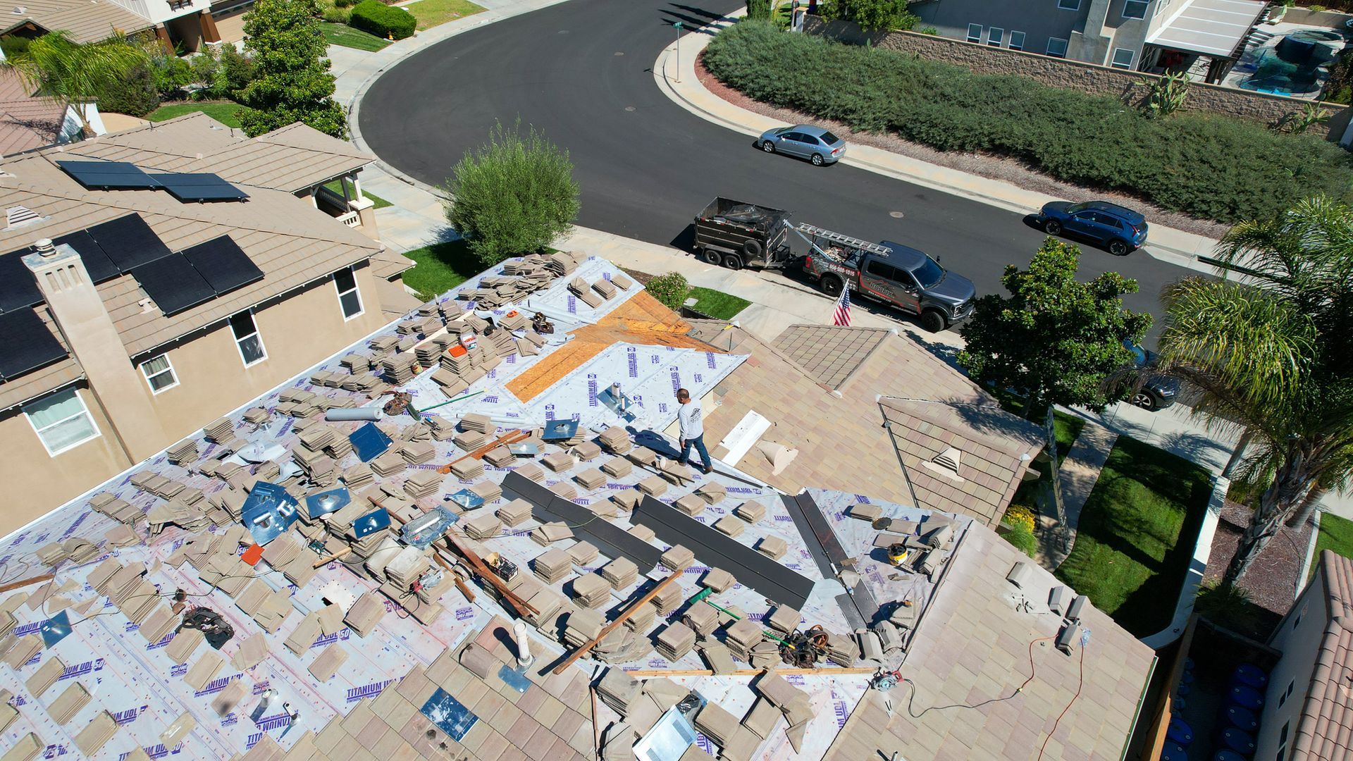 An aerial view of a roof that is being repaired