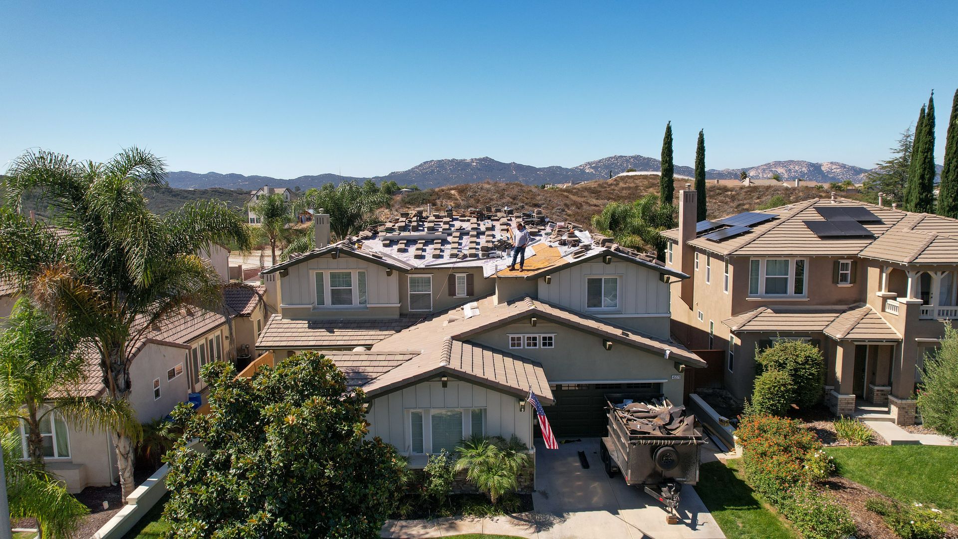 An aerial view of a residential area with houses and trees