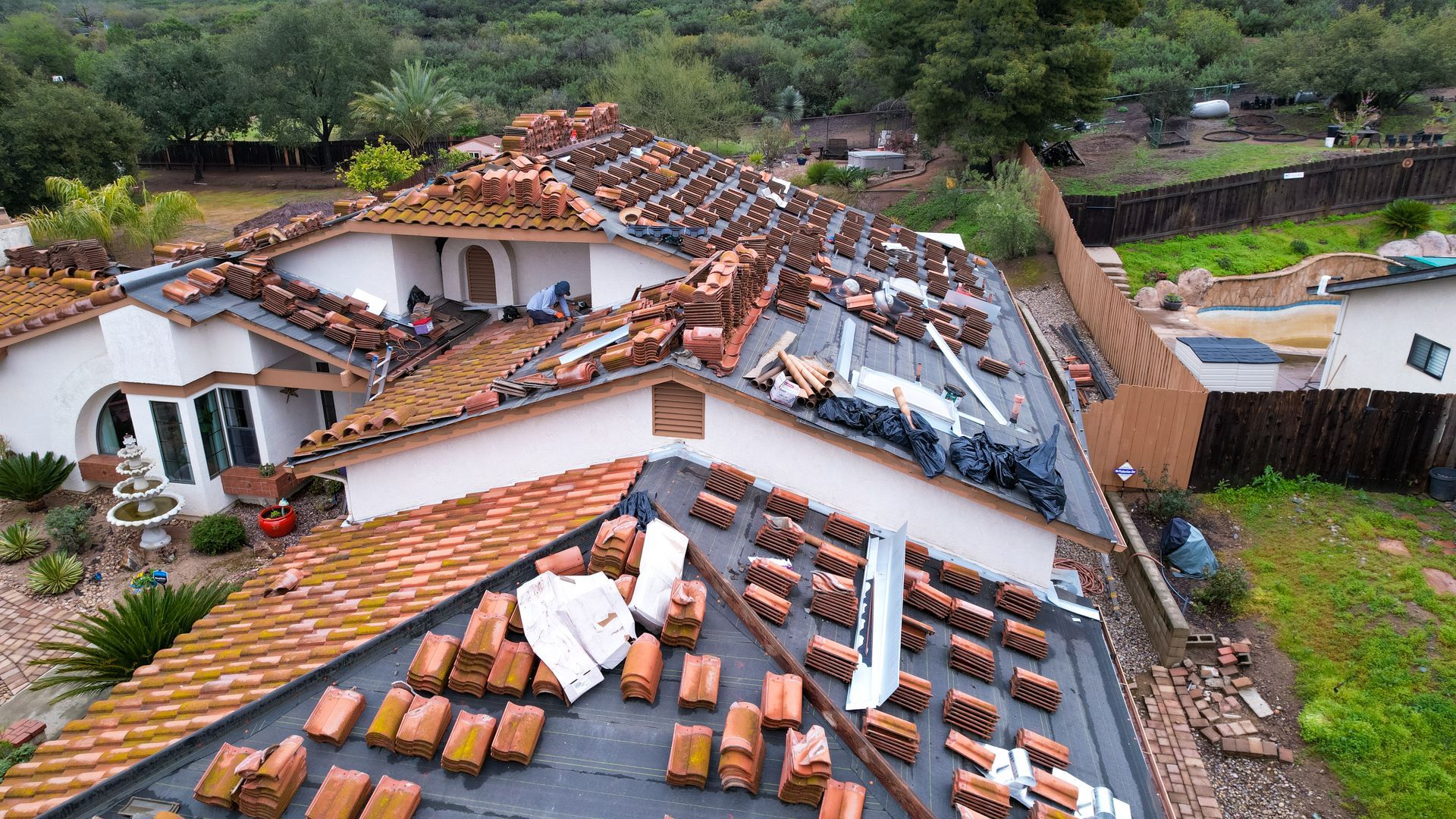 An aerial view of a damaged roof of a house