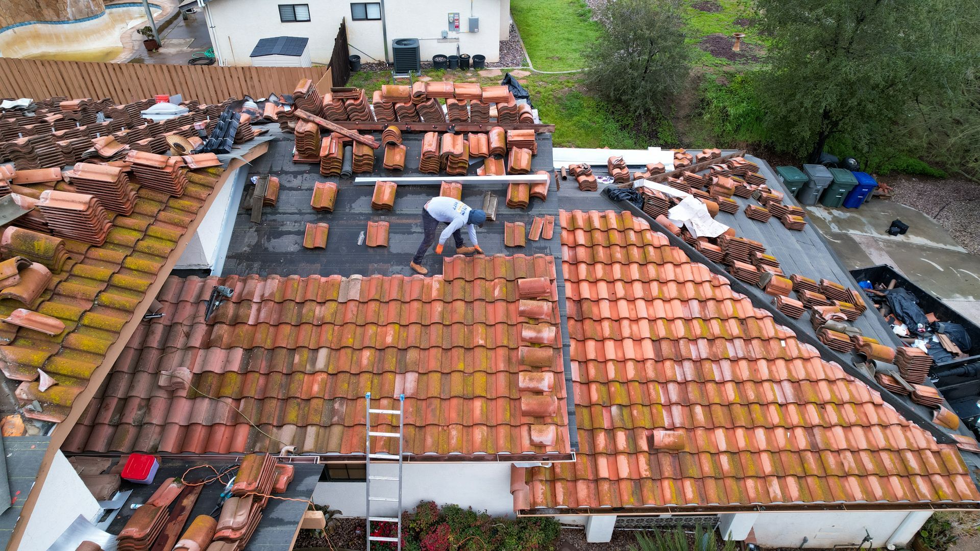 A man is working on the roof of a house