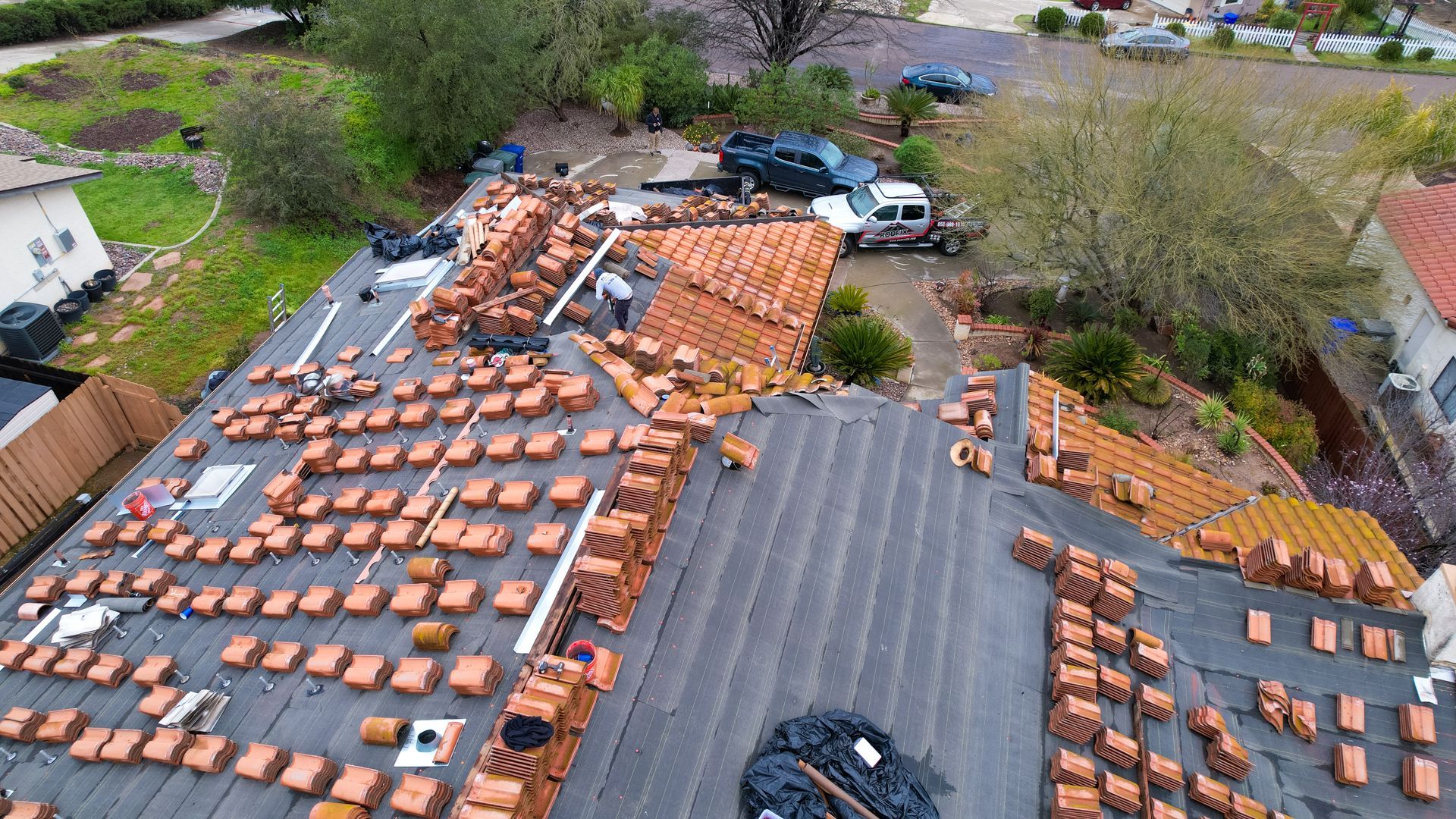 An aerial view of a roof that is being repaired.
