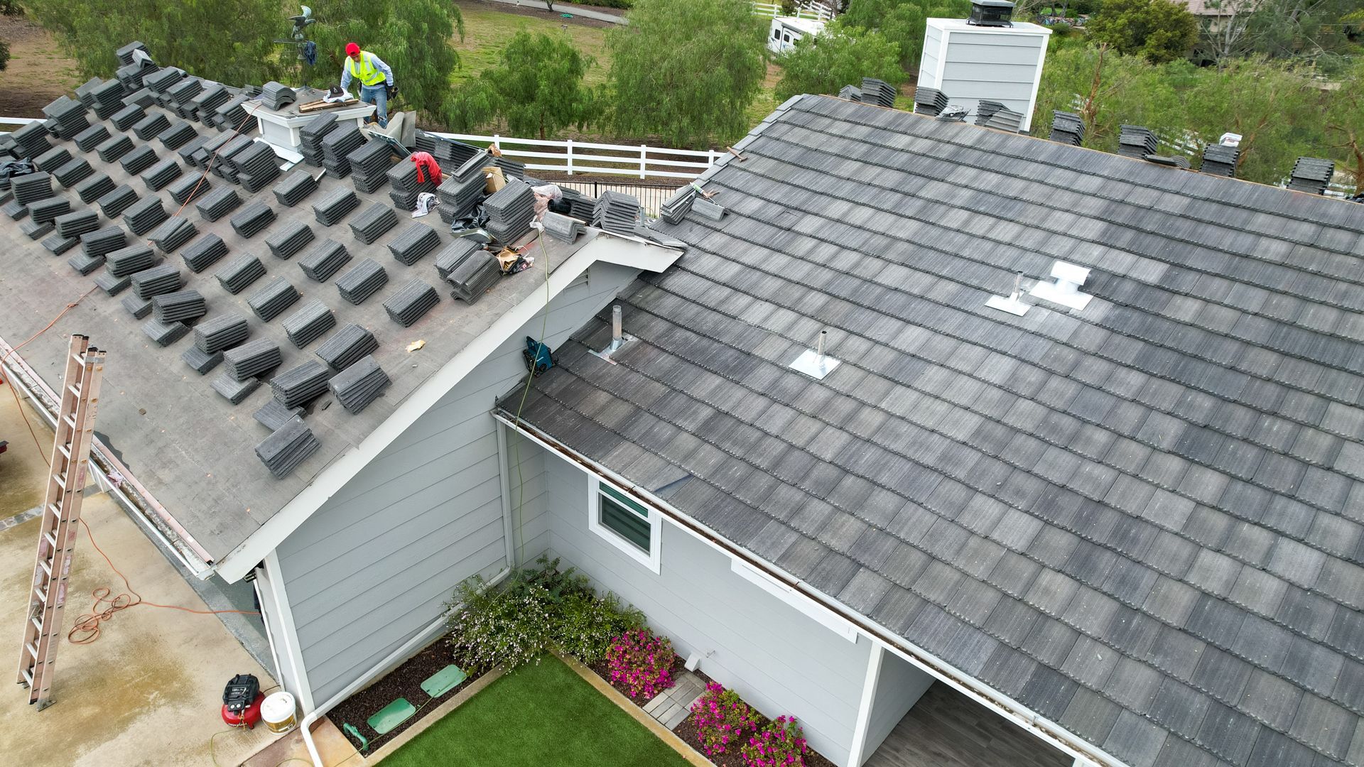 An aerial view of a house with a roof being installed