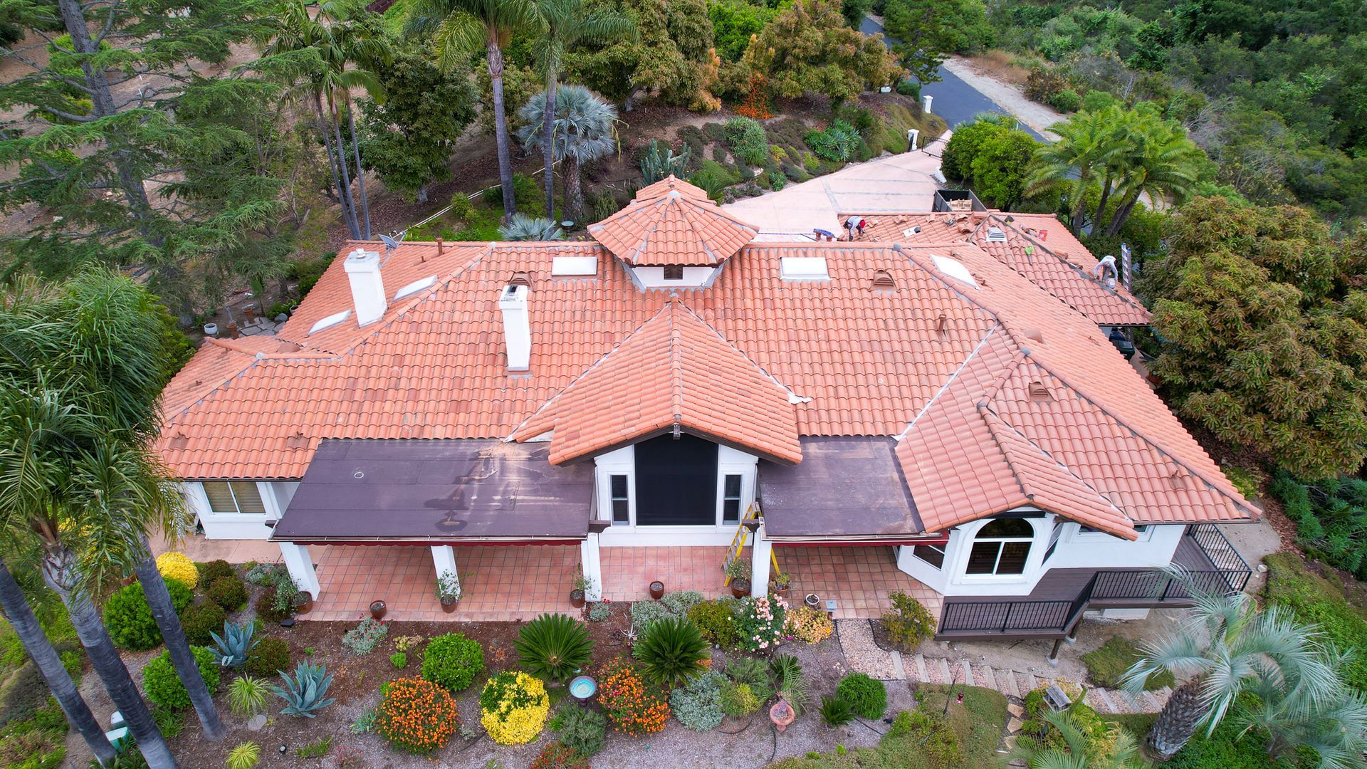 An aerial view of a large house with a tiled roof