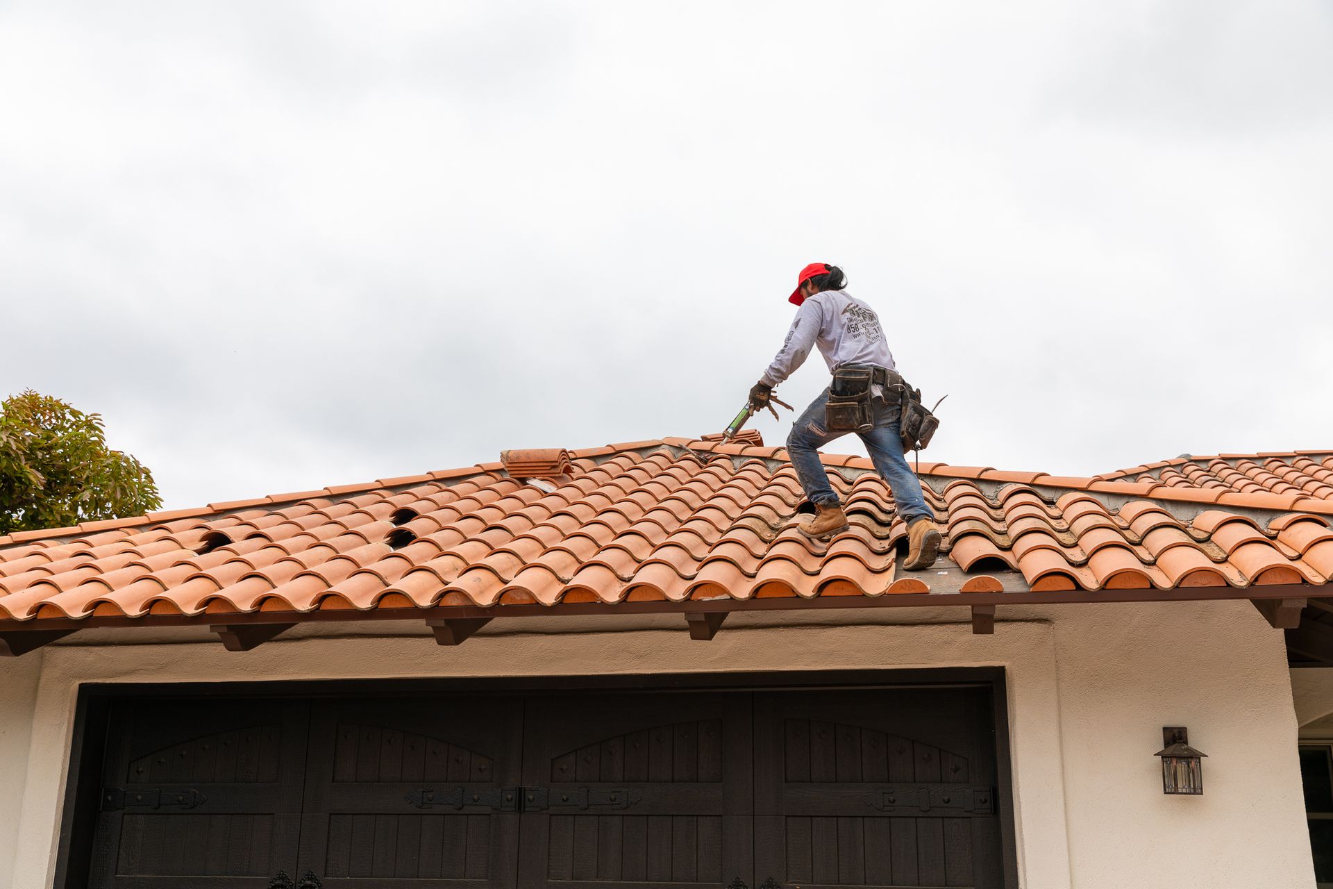 A man is working on the roof of a house