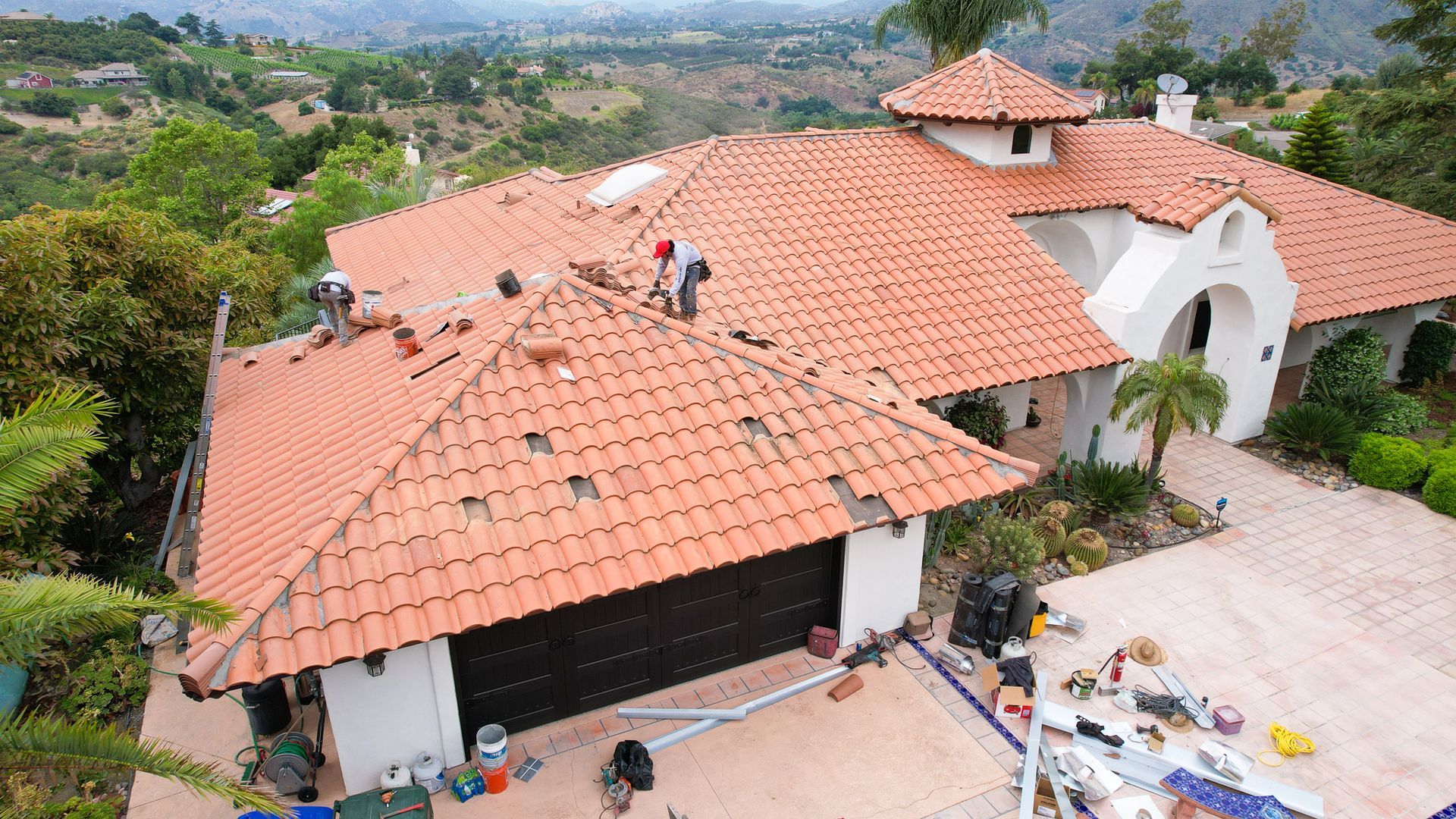 An aerial view of a house with a red tiled roof