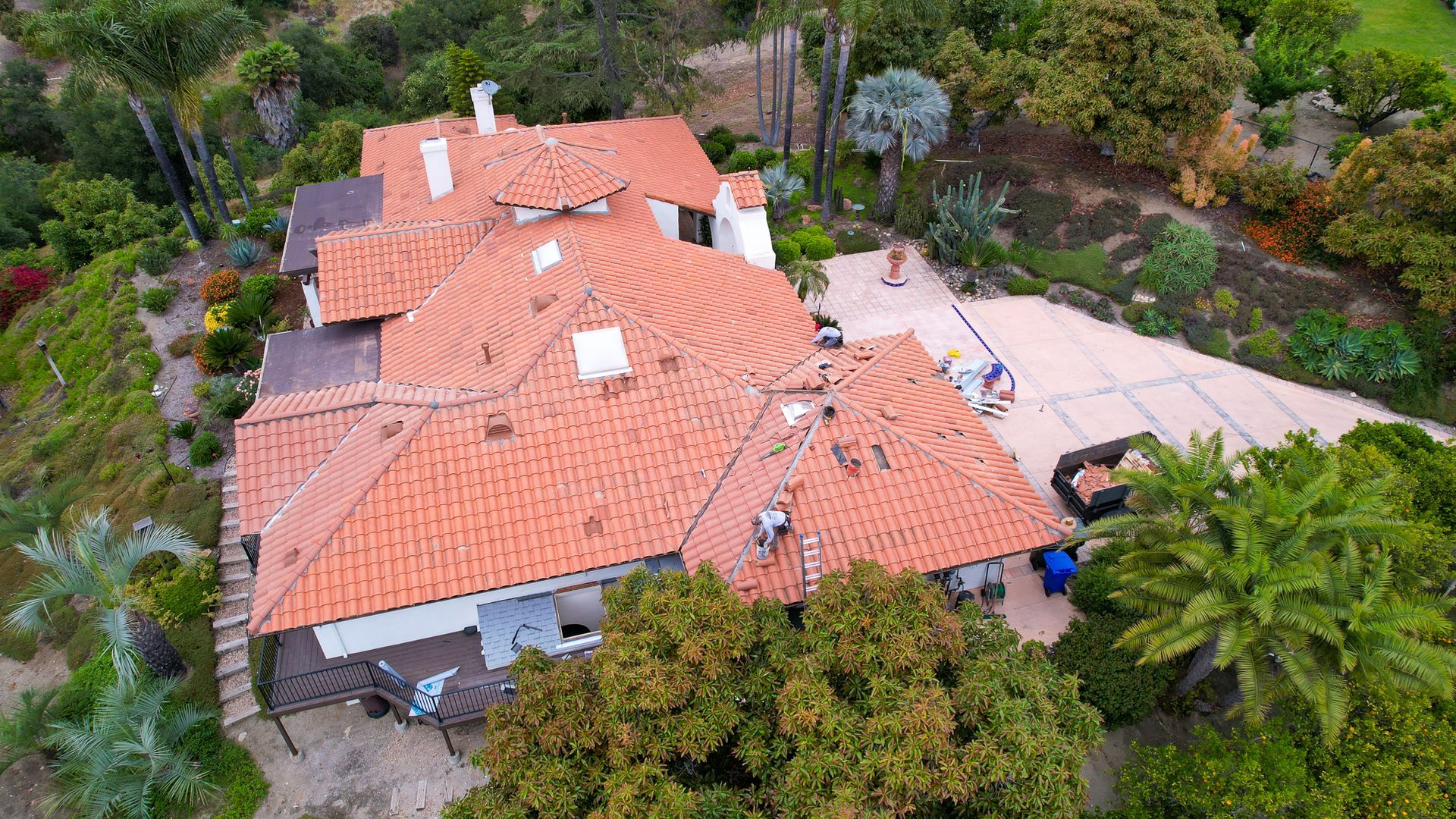 An aerial view of a house with a red tile roof