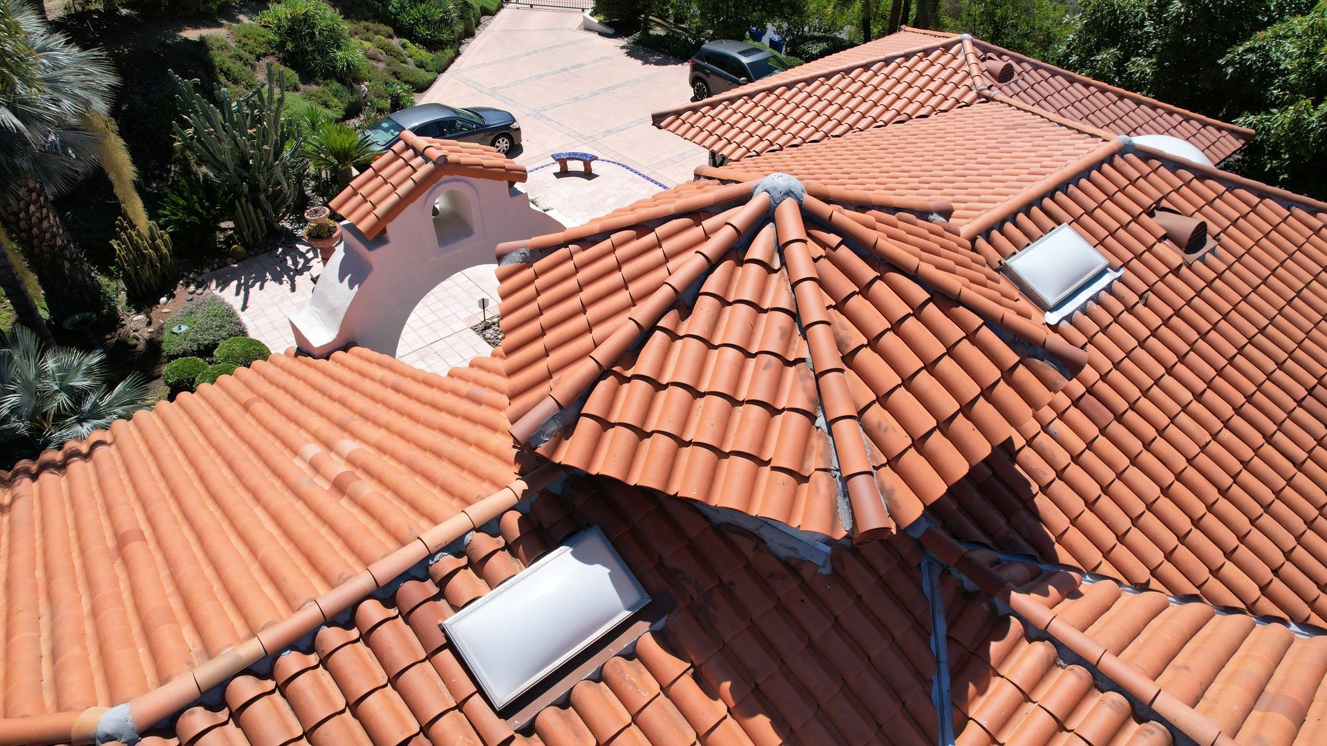 An aerial view of a house with a red tiled roof