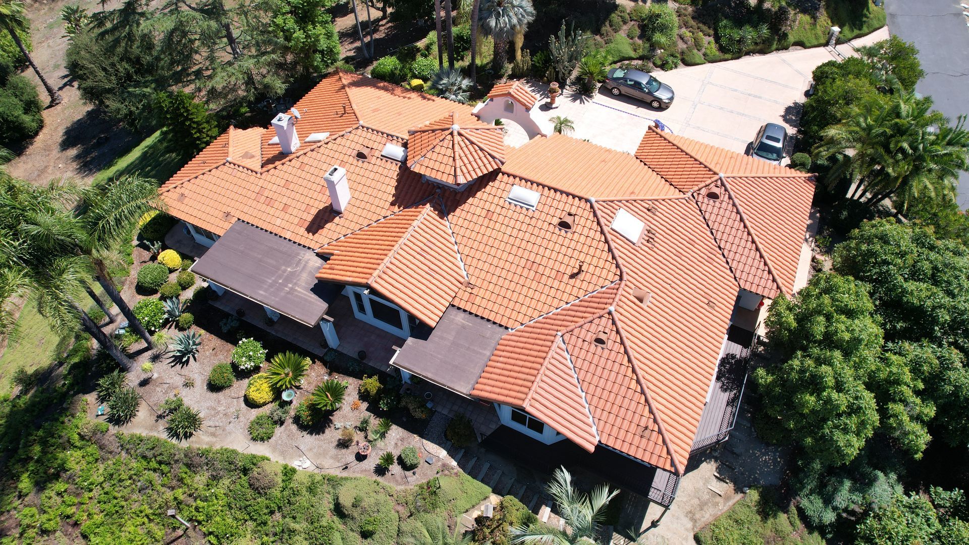 An aerial view of a large house with a tiled roof