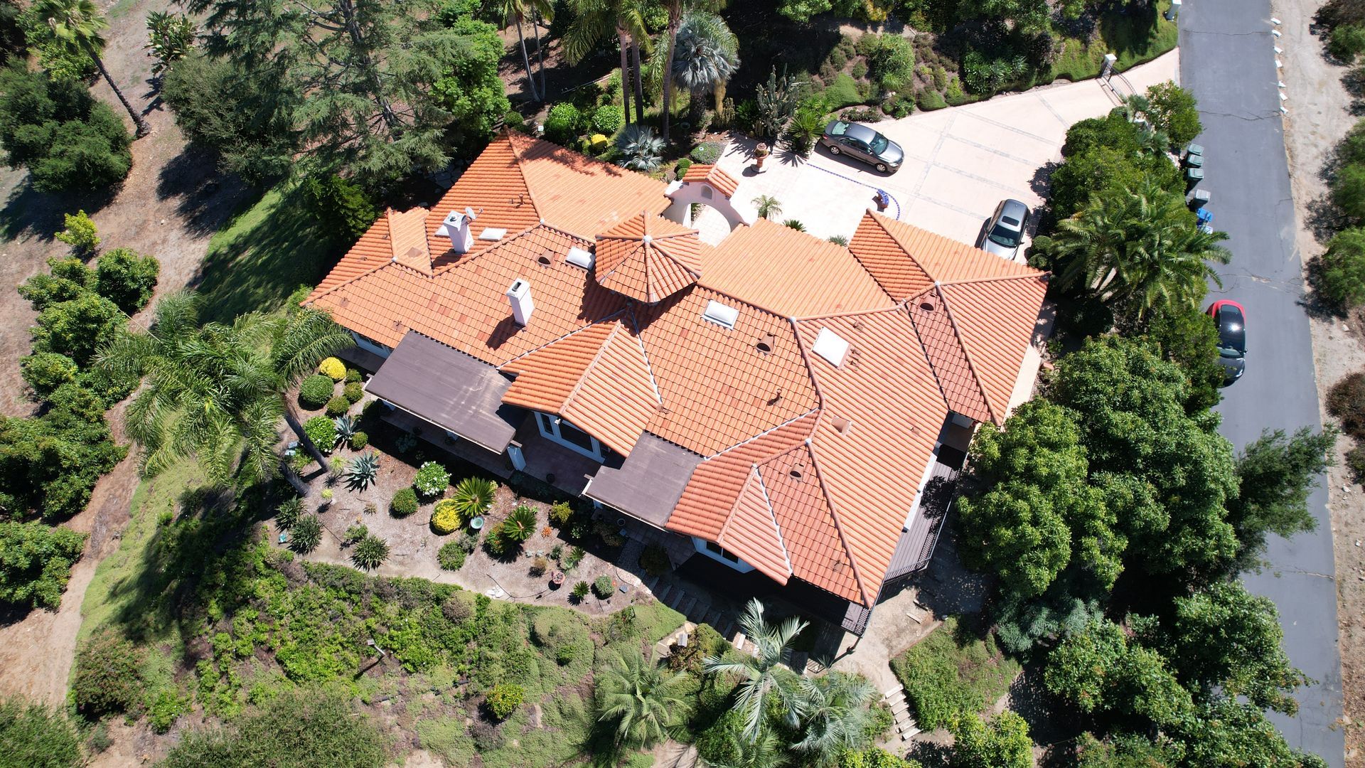 An aerial view of a house with a red tile roof