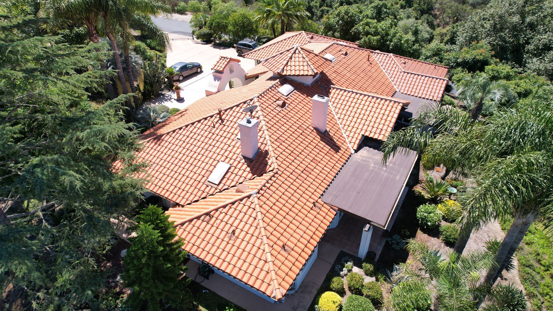 An aerial view of a house with a red tiled roof