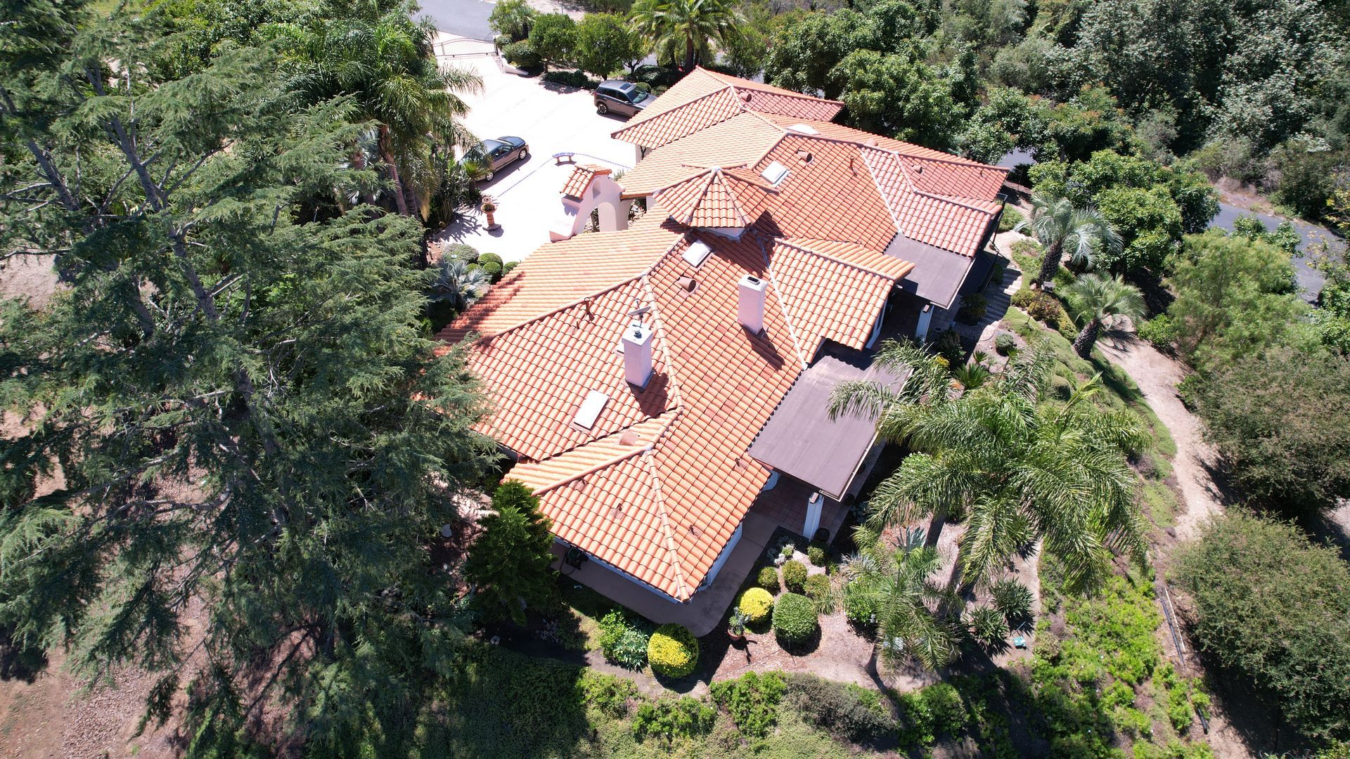 An aerial view of a house with a red tiled roof