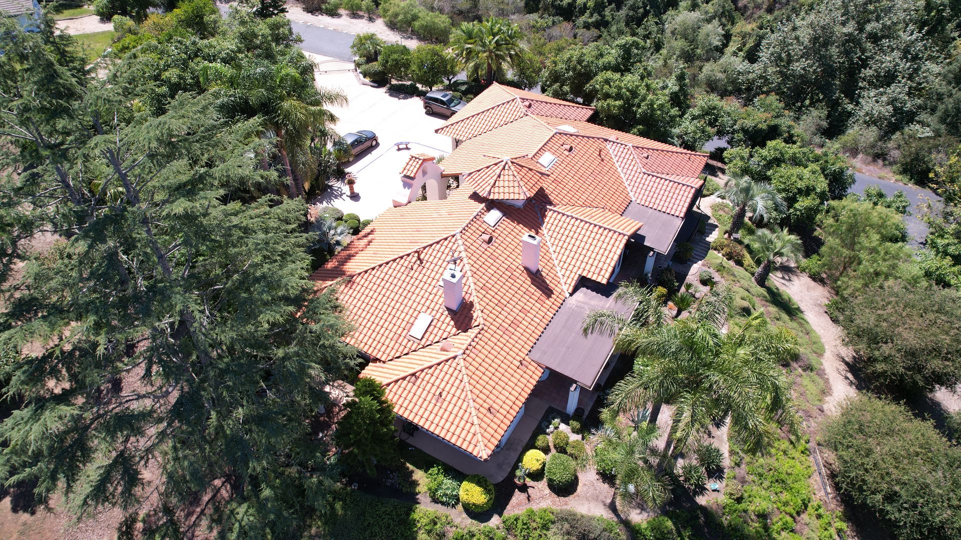 An aerial view of a house with a red tile roof