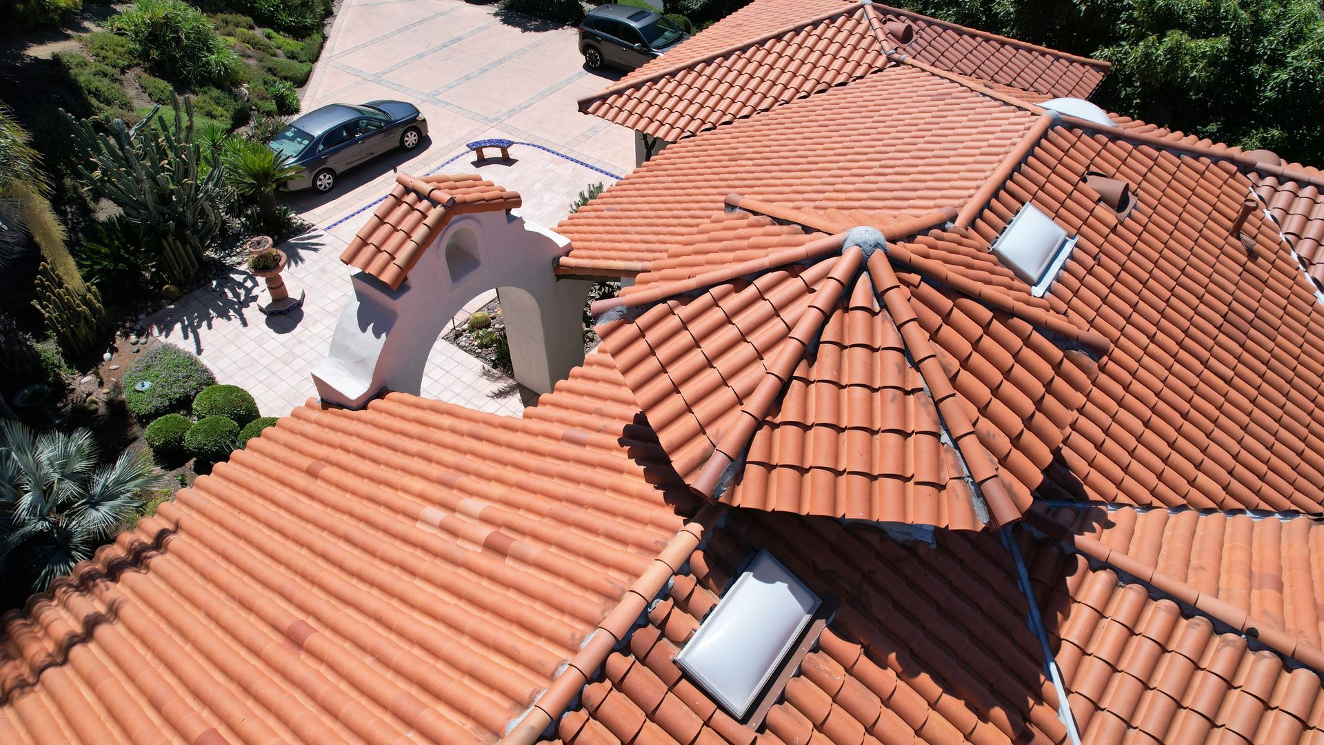 An aerial view of a house with a red tiled roof