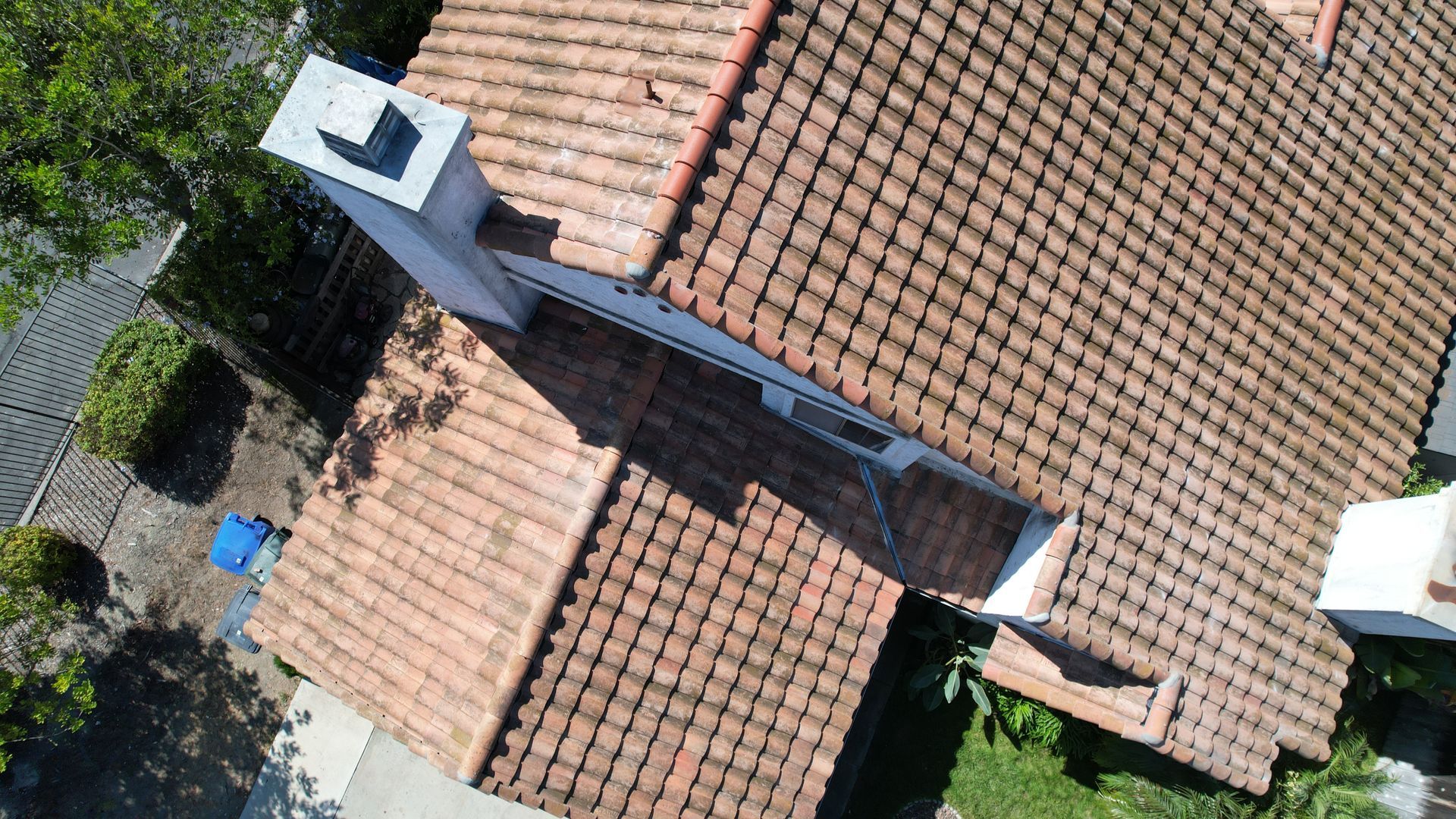 An aerial view of a house with a chimney on the roof