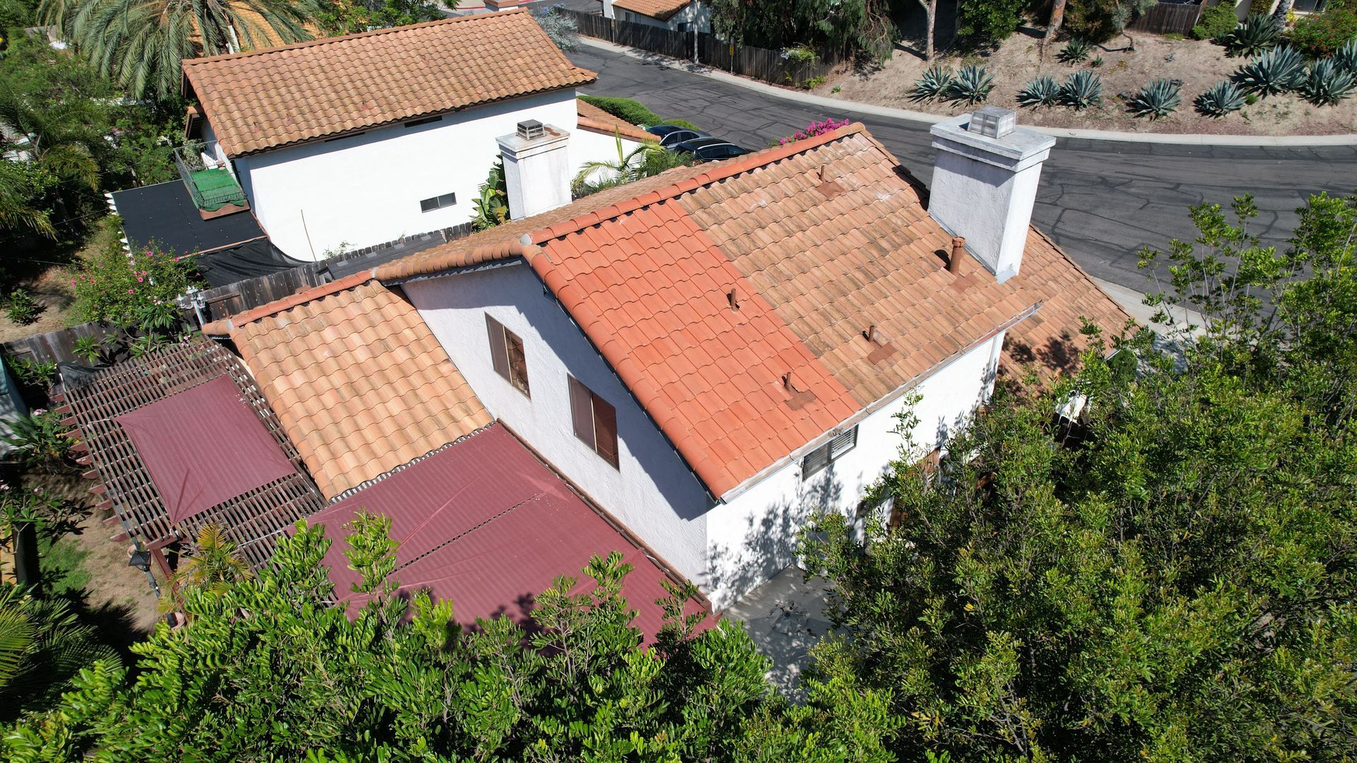 An aerial view of a house with a red tiled roof