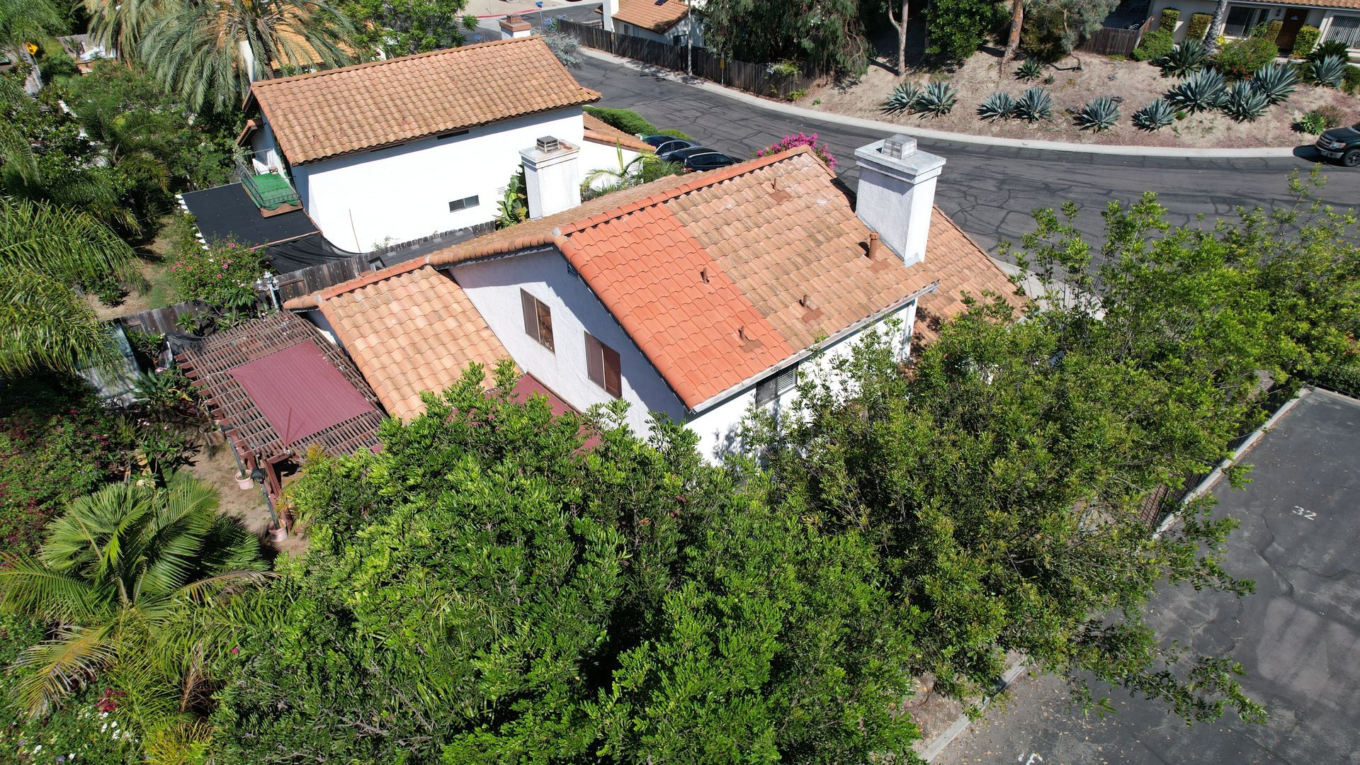 An aerial view of a house with a red tile roof