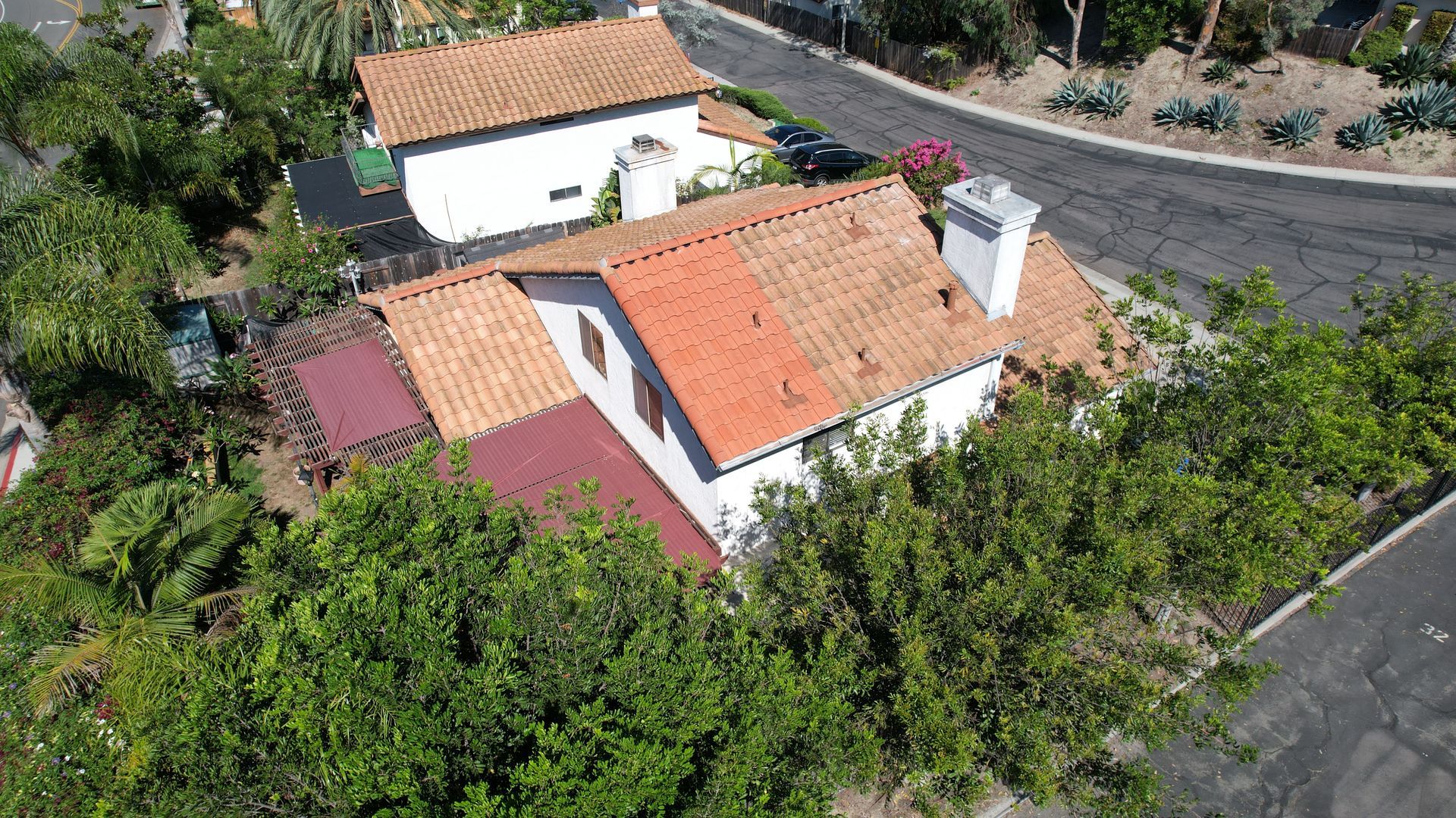 An aerial view of a house with a red tiled roof