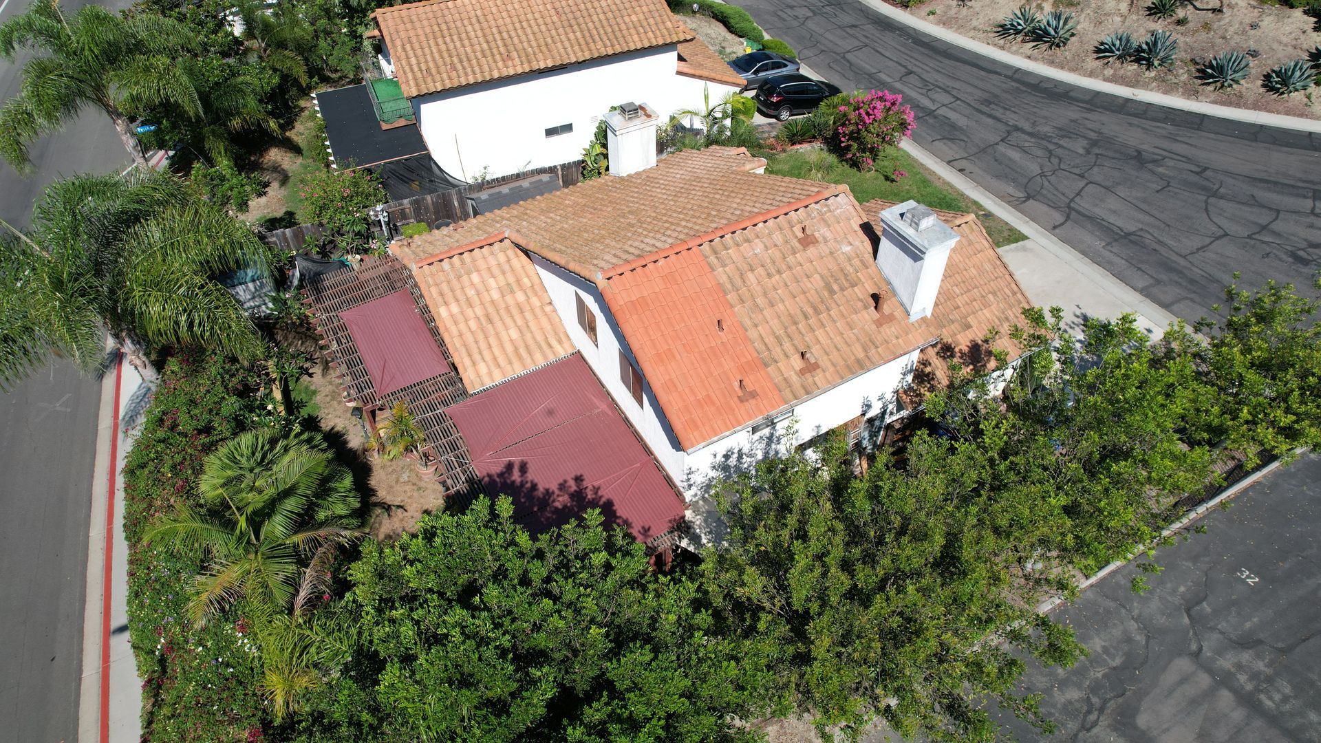 An aerial view of a house with a red roof