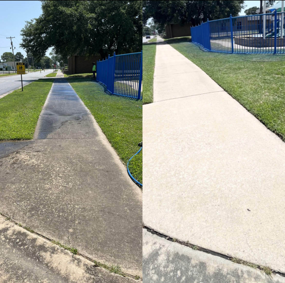 Person pressure washing a walkway with building and signage in the background. The walkway is wet and foamy.