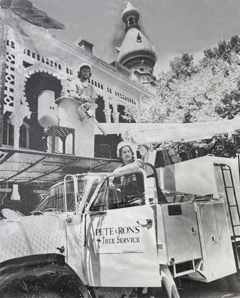 A black and white photo of a petersons tree service truck