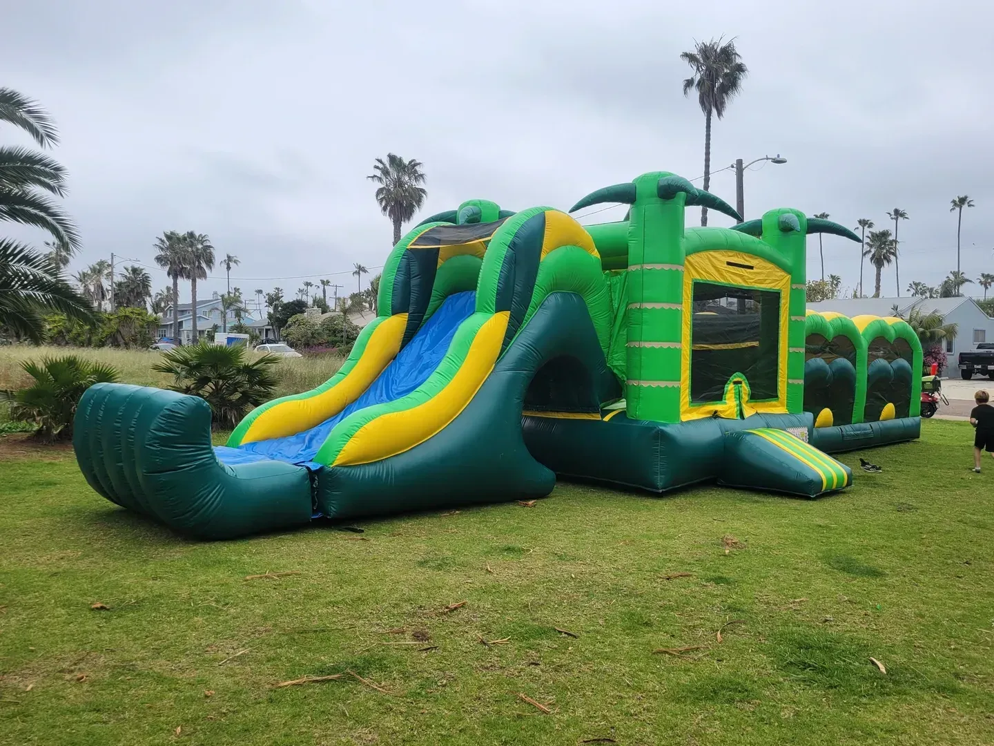 A large black inflatable tent is sitting on top of a lush green field.