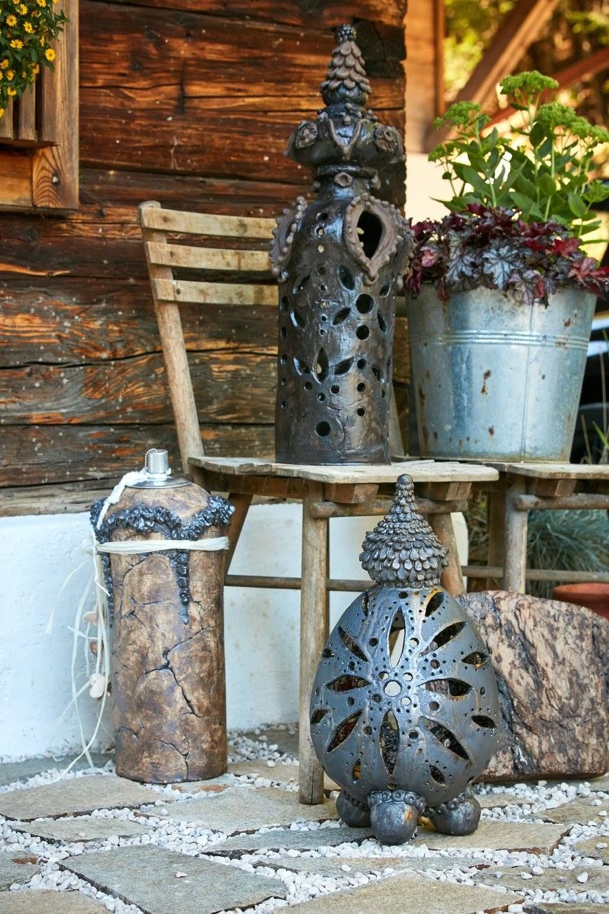 Neben einem Tisch steht ein Holzstuhl, auf dem Topfpflanzen stehen.