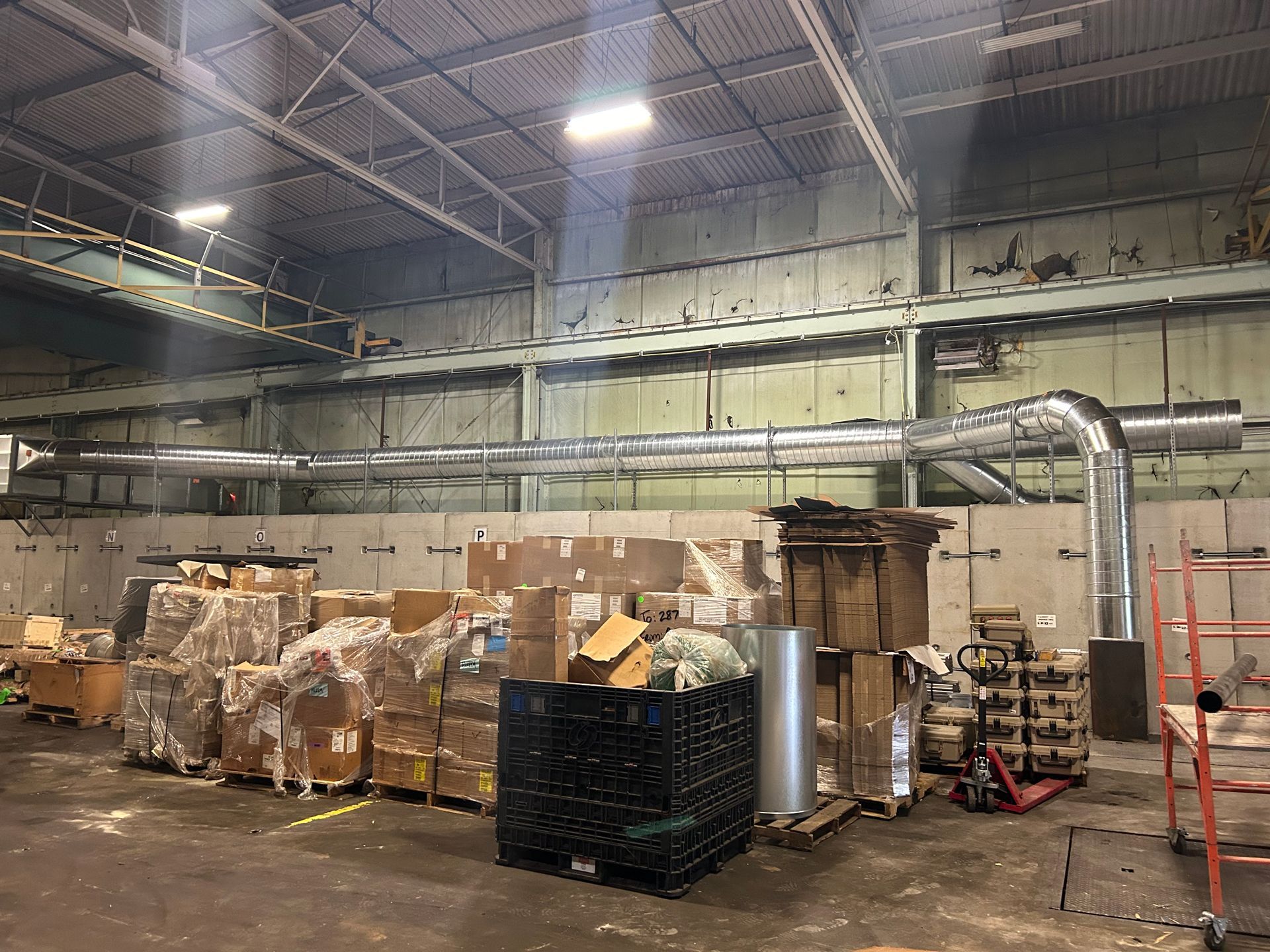 A Large Warehouse Filled With Lots of Boxes and Pipes