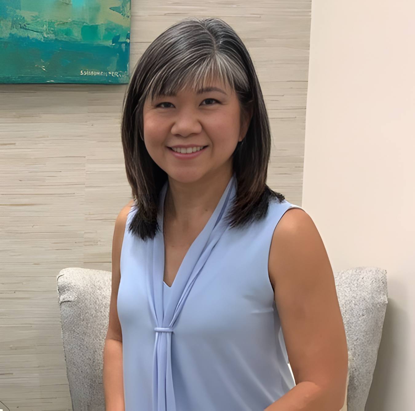 Wendy sitting in a chair with a light blue shirt