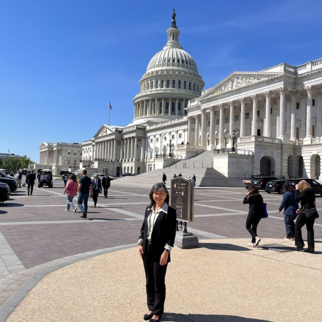 Volunteers at a Kidney Walk check-in table wearing orange shirts. Banner says 