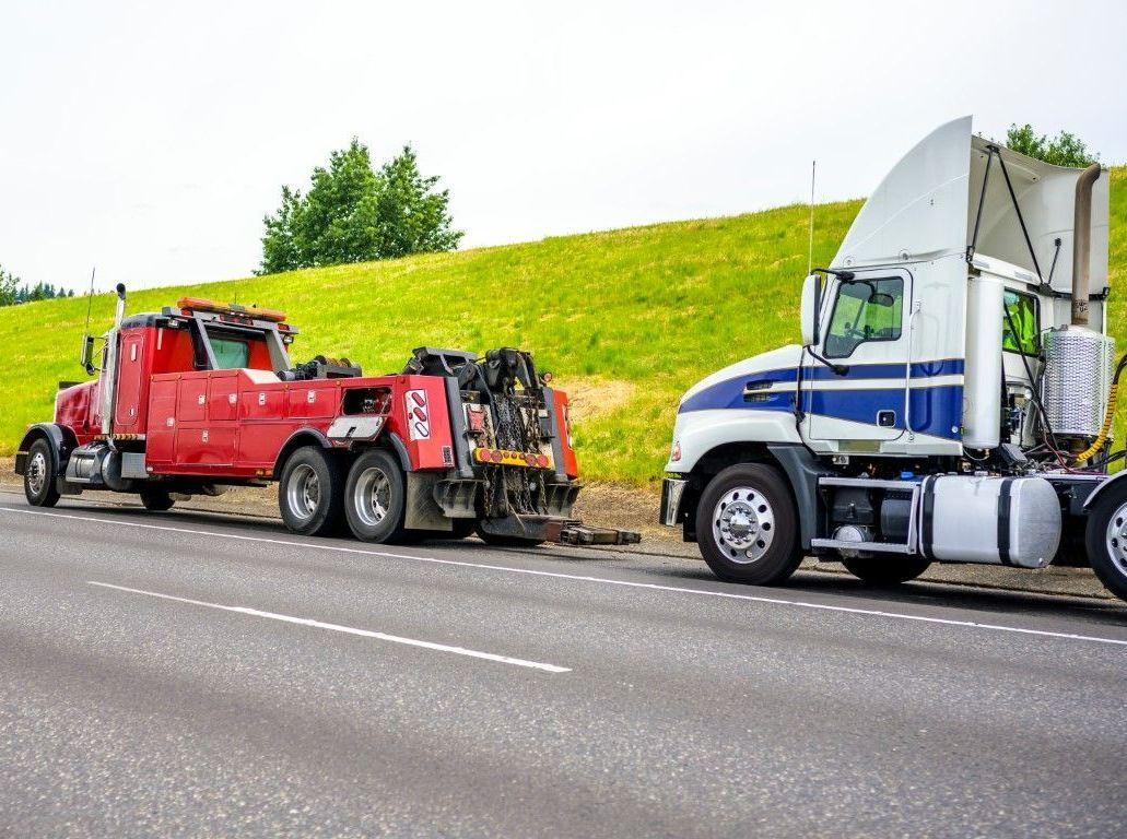 Tow truck in front of a roadside vehicle-Towing Service in progress