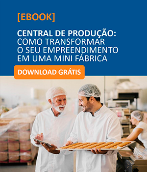 Dois homens segurando uma bandeja de comida em uma fábrica