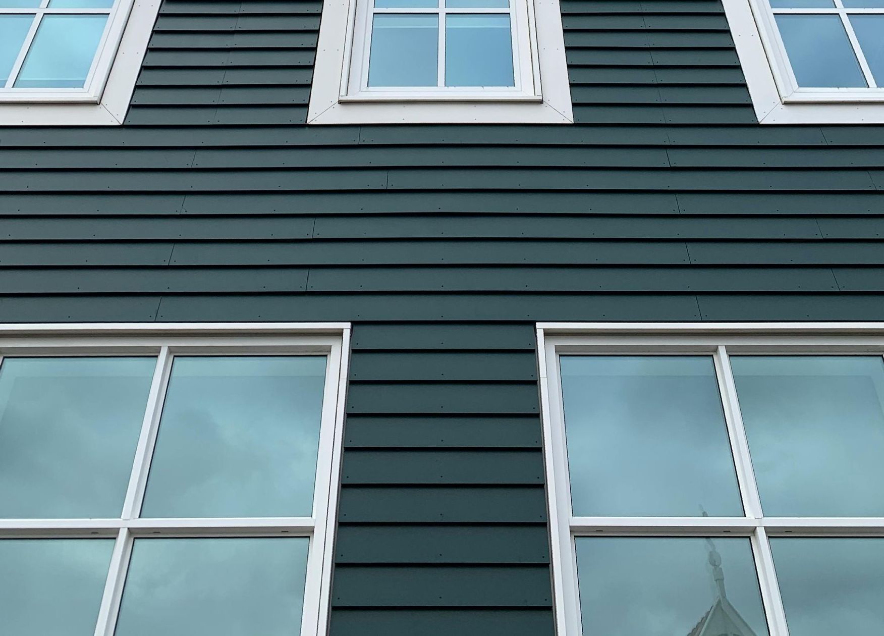 turqoise vinyl siding installation on two story residential home in West Springfield MA