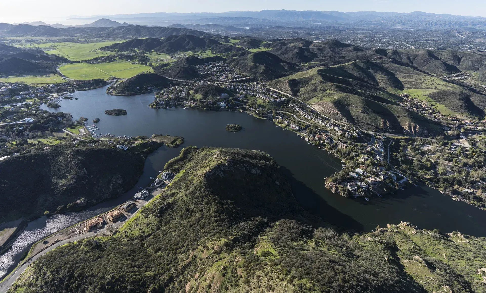 An aerial view of a lake surrounded by mountains
