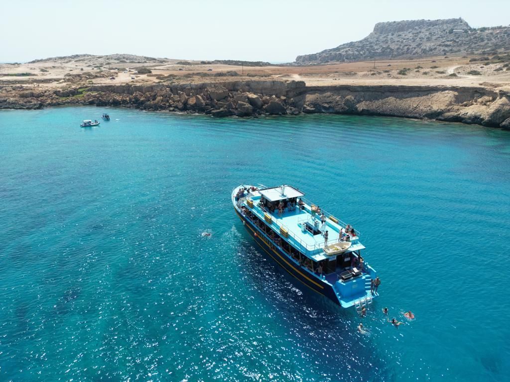 A boat is floating on top of a body of water.