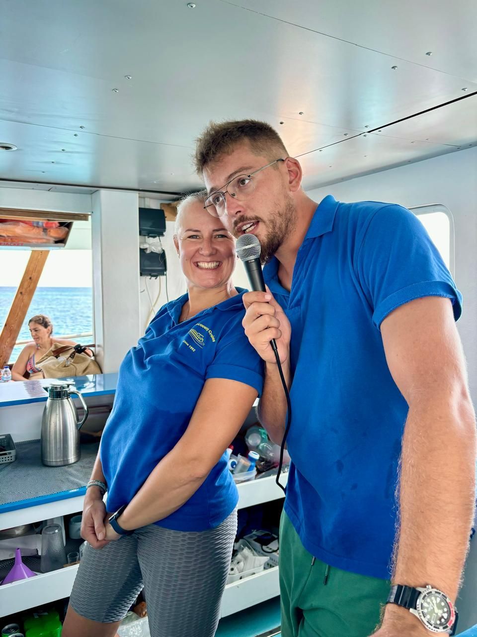 A man is holding a microphone while standing next to a woman