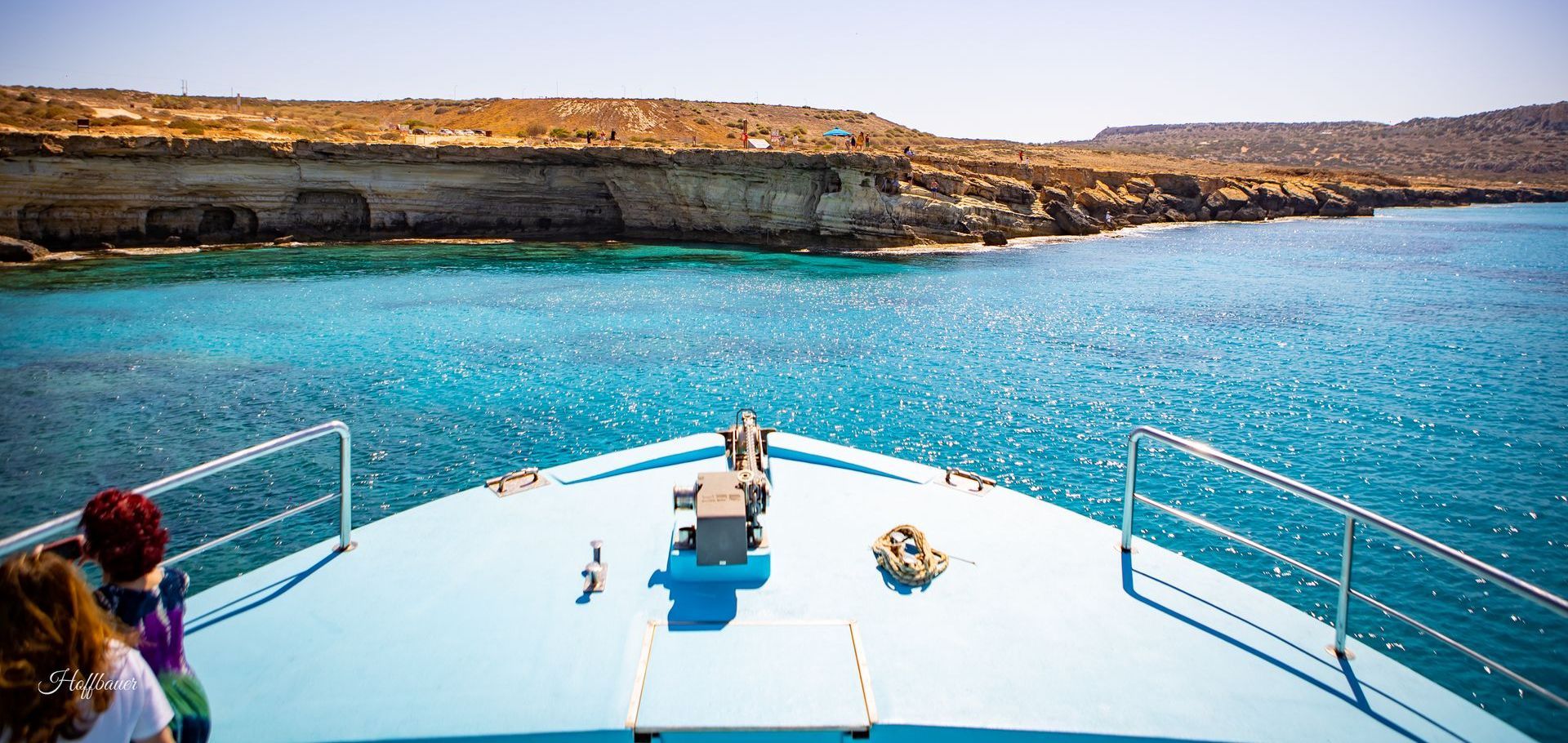 A boat is floating on top of a body of water.