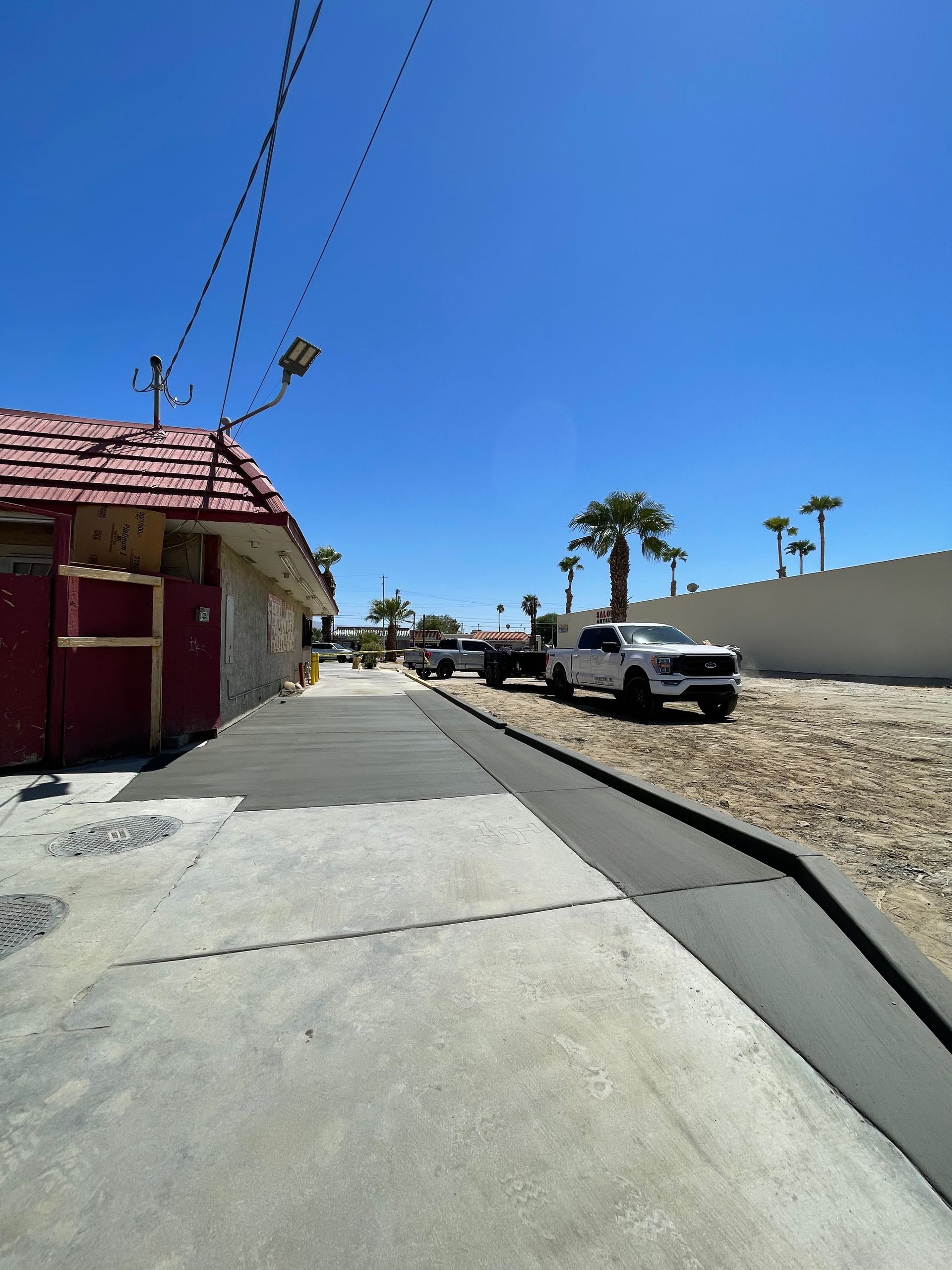 A white truck is parked on the side of the road