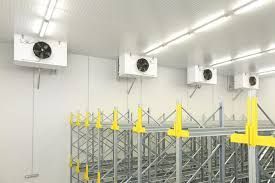 a warehouse with a lot of shelves and fans on the ceiling. Industrial Cold Storage