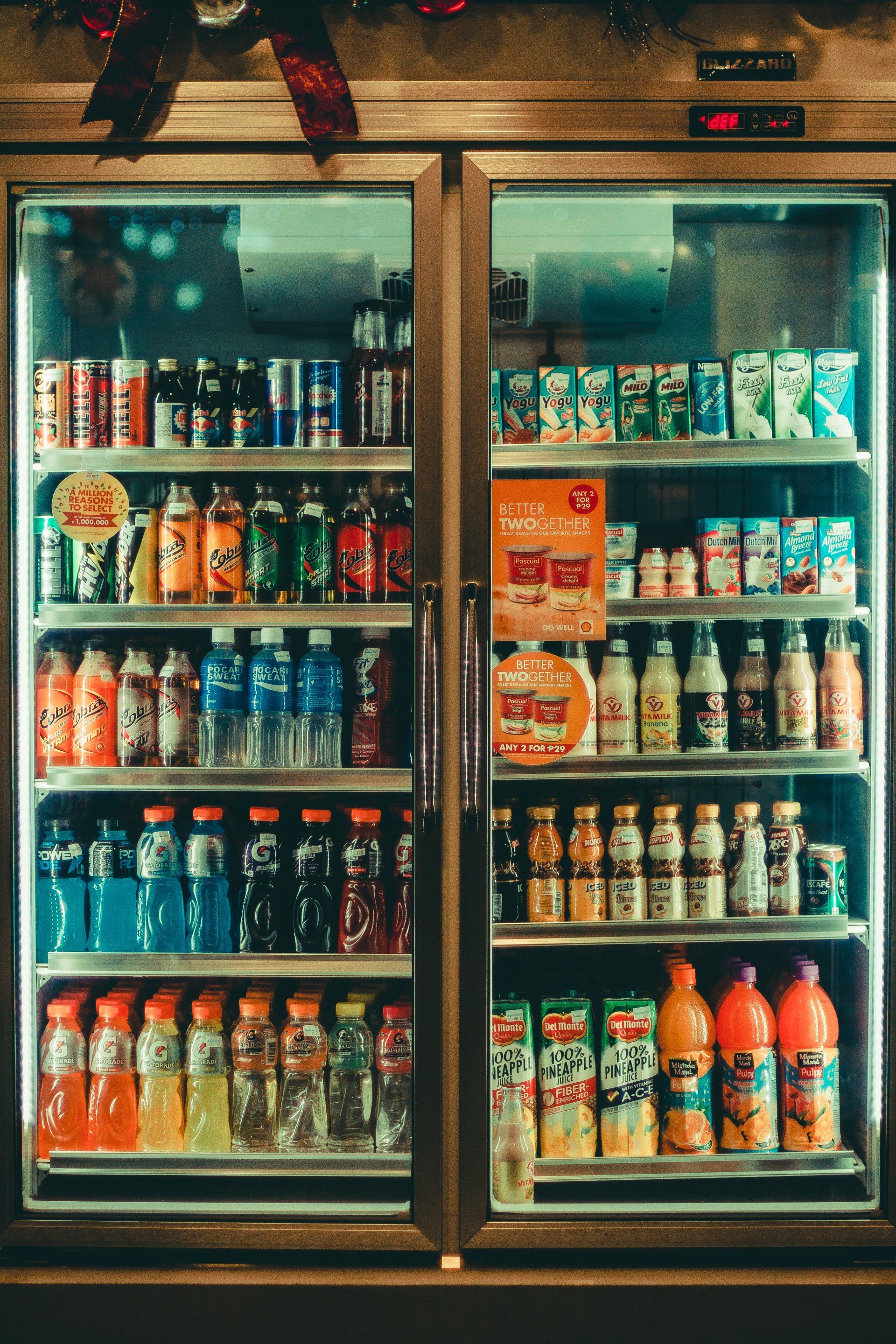 a refrigerator filled with lots of drinks and cans .