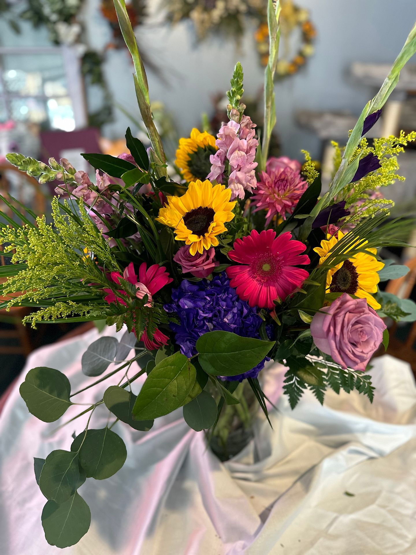 A vase filled with colorful flowers is sitting on a table.