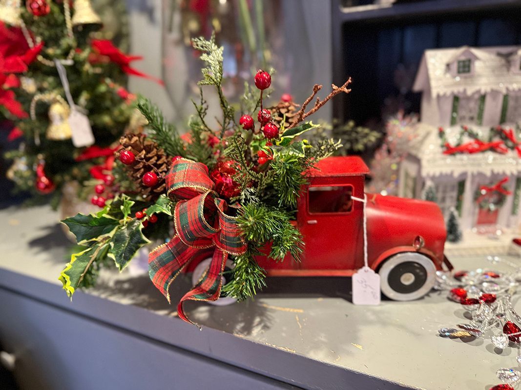 Two green vases filled with succulents are sitting on a table next to a bicycle.