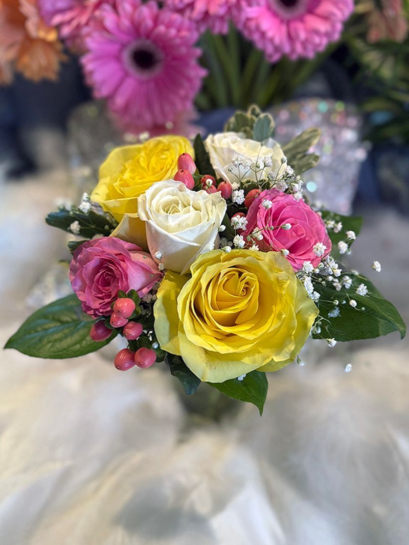 Two pink flowers are sitting on top of a green cloth.