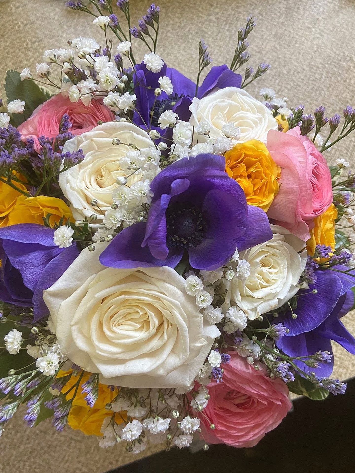 A close up of a bouquet of flowers on a table.