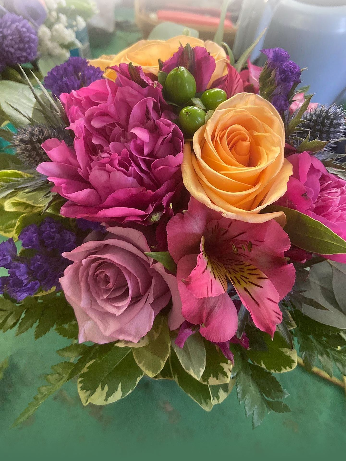 A close up of a bouquet of flowers on a table.