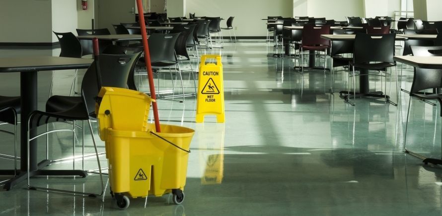 A living room with a couch , chair , table and large windows.
