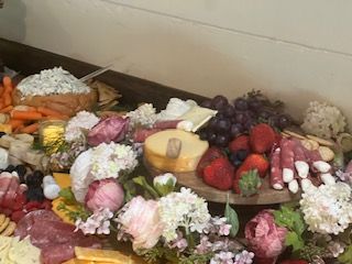 A table topped with a variety of food and flowers.