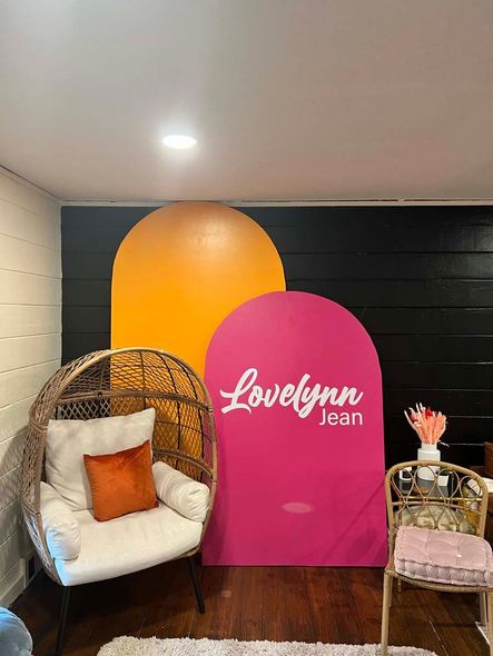 A room with a chair and a sign that says lovelynn jean.