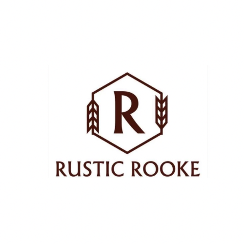 A table with a cake and a sign that says rustic rooke keir on it.
